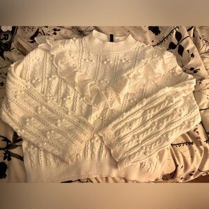 White sweater with ruffle embellishment